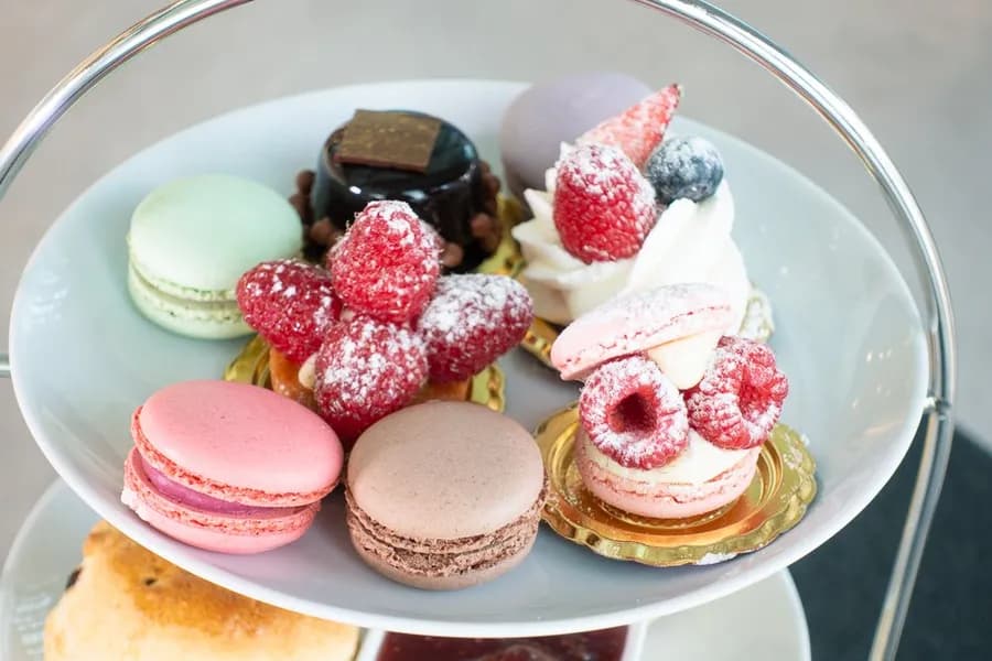 The top tier of the By Eric Afternoon Tea stand, with macarons and tarts